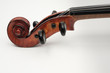 CLose up view of a violin with white plain background.