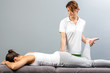© karelnoppe - Female therapist doing osteopathic leg manipulation on patient.