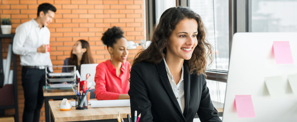 Businesswoman working in the office with multiethnic colleagues