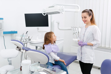 Wall Mural - Dentist and small girl in cabinet