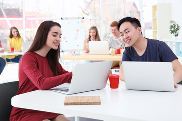 Poster - Young people working with laptops in office