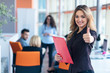 © FS-Stock - portrait of young business woman at modern startup office interior showing thumbs up