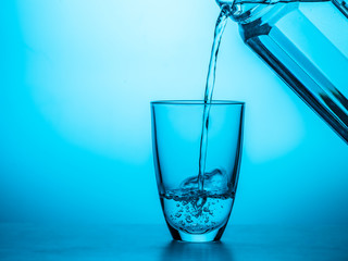 Wall Mural - Man pours water from glass