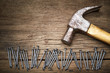 Hammer and nails on old wood background