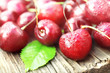 Pile of sweet fresh cherries on wooden background