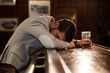 © Drobot Dean - Drunk man sleeping on a pub counter