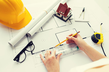 Poster - close up of hands with ruler measuring blueprint