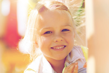 happy little girl climbing on children playground