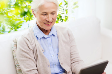 Wall Mural - happy senior woman with tablet pc at home