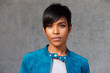© mimagephotos - Close up trendy young black woman with blue jacket