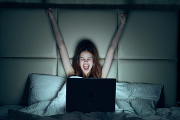 Happy woman, woman sitting in bed, woman with laptop