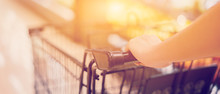 Female Hand Close Up With Shopping Cart In A Supermarket Walking Trough The Aisle,trolley In Department Store Bokeh Background,vintage Color,copy Space
