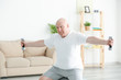 © Africa Studio - Fat senior man training with dumbbells at home. Weight loss concept
