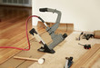 © GalinaSt - SaveDownload PreviewInstalling of beautiful bamboo hardwood floor with pneumatic tool