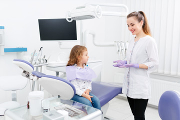 Wall Mural - Dentist and small girl in cabinet