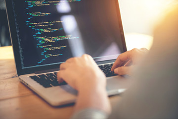 Wall Mural - closeup coding on screen, woman hands coding html and programming on screen laptop, development web,