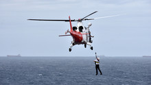 Pilot Is Disembarking From Cargo Ship By Helicopter