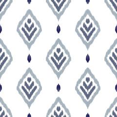 Wall Mural - Ikat seamless pattern. Fancy textile design. Vector illustration in ethnic style.