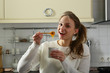 © Елена Кравчук - Beautiful girl positive eating organic honey on kitchen indoor