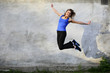 © Елена Кравчук - Happy smiling jump sport beautiful young woman on gray background