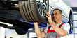 Motor mechanic changes a tyre