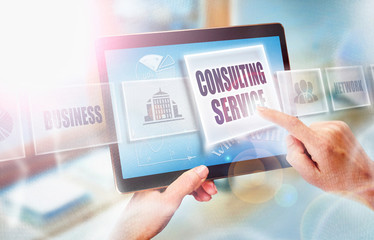 Wall Mural - A businesswoman selecting a Consulting Service business concept on a futuristic portable computer screen.