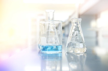 blue solution in beaker and flask with science laboratory