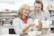 © highwaystarz - Teacher With Mature Woman Making Mug In Pottery Class
