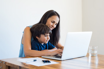 Mother working at home with son