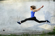 © Елена Кравчук - Sport bright beautiful strong woman in a jump fly jumping on gray background