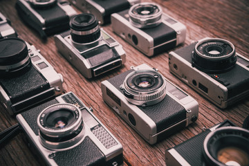 Retro film photo camera on wooden background