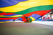 © Sarah Rypma - Children playing underneath colourful parachute