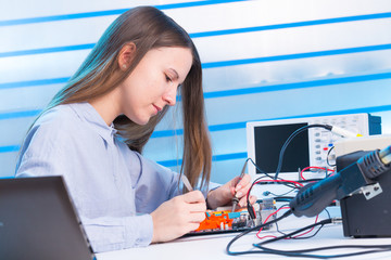 Canvas Print - Young woman fix PC component in service center