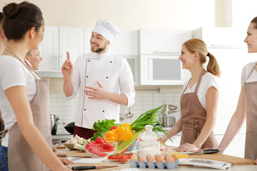 Male chef and group of people at cooking classes