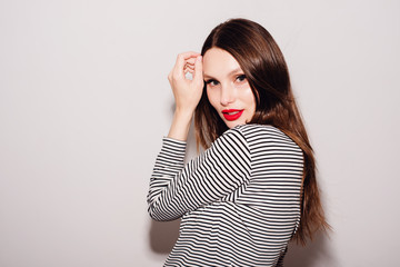 Wall Mural - Close-up portrait of a beautiful woman with bright make-up in striped clothes