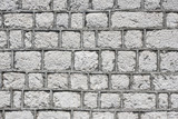 Fototapeta  - Gray brick wall made of uneven blocks pattern.