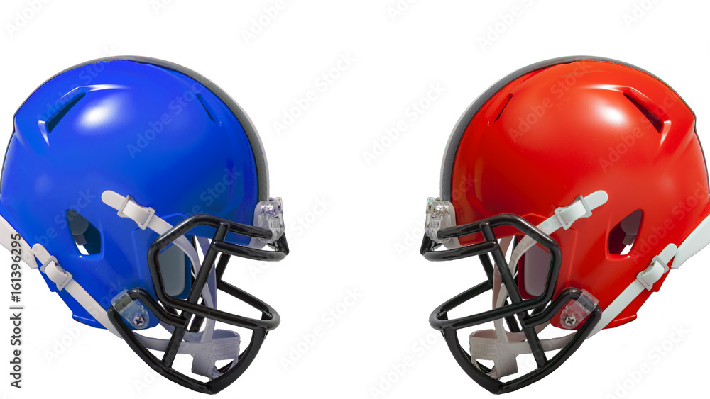 Athletic rivalry, sports encounter or red vs blue concept with two american football helmets facing each other in conflict, the red helmet versus the blue helmet with copy space Stock Photo | Athletic rivalry, sports encounter or red vs blue concept with two american football helmets facing each other in conflict, the red helmet versus the blue helmet with copy space Stock Photo |