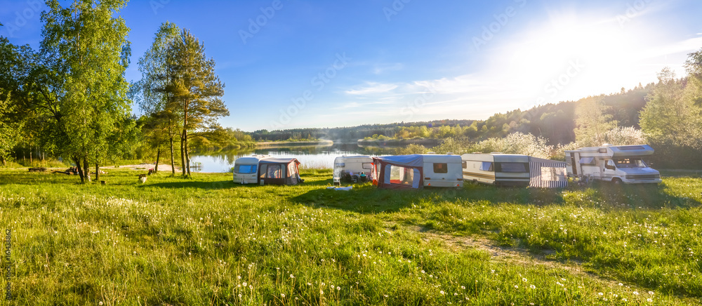 Caravans and camping on the lake. Family vacation outdoors, travel concept - obrazy, fototapety, plakaty 