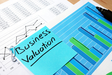 piece of paper with words business valuation and financial data.