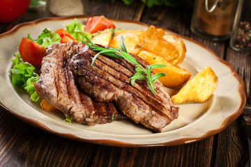 Wall Mural - Succulent portions of grilled fillet mignon served with baked potatoes