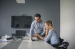 © liderina - Business woman and business man working together in office. Business people working on laptop.