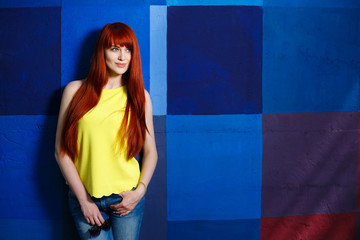 youth, city style, women fashion, outerwear, jeans wear. young stylish slim girl with long red hair 