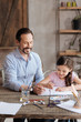 © zinkevych - Little daughter and his father painting with watercolors