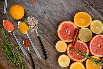 the fragrance of spices, red pepper, black pepper, mustard,sunflower seeds ,and orange slices of citrus fruits on dark wooden background of the table.