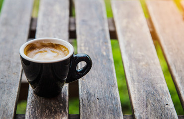 Wall Mural - cup of coffee on wood table background