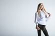 © julenochek - Casual young fashionable woman with a bag in light background