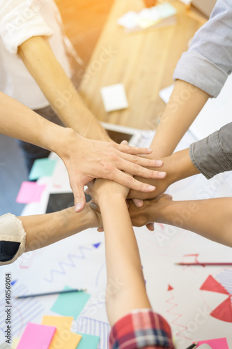 Fotografija Close up hand's asian group professional colleagues join hands together at modern office workplace