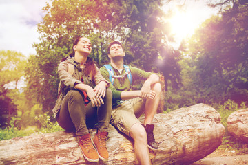 Wall Mural - smiling couple with backpacks in nature