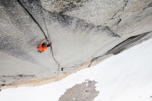 Climbers High Up On Mountain Face Climbing Cracks