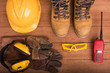 Standard construction safety equipment on wood background